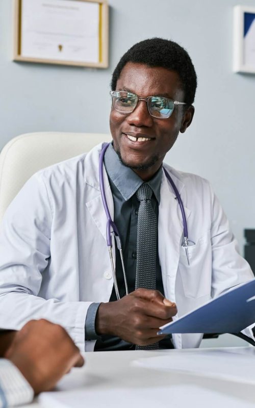 smiling-black-doctor-consulting-female-doctor-in-clinic.jpg